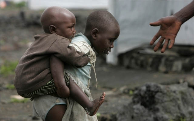 Ребенок в Конго измельчает кобальтовую руду, чтобы заработать на еду